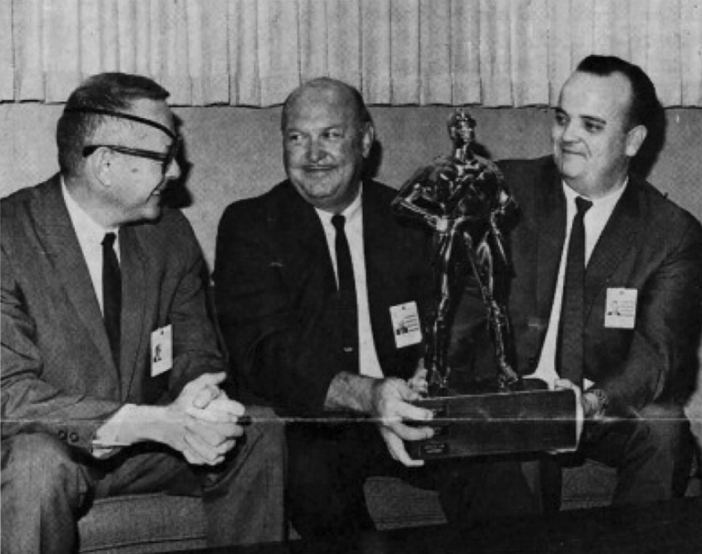 trophy being awarded to staffers