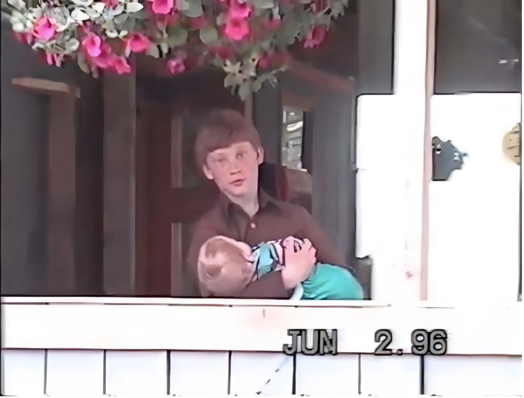 A boy holds a baby at the Farm at Game Creek
